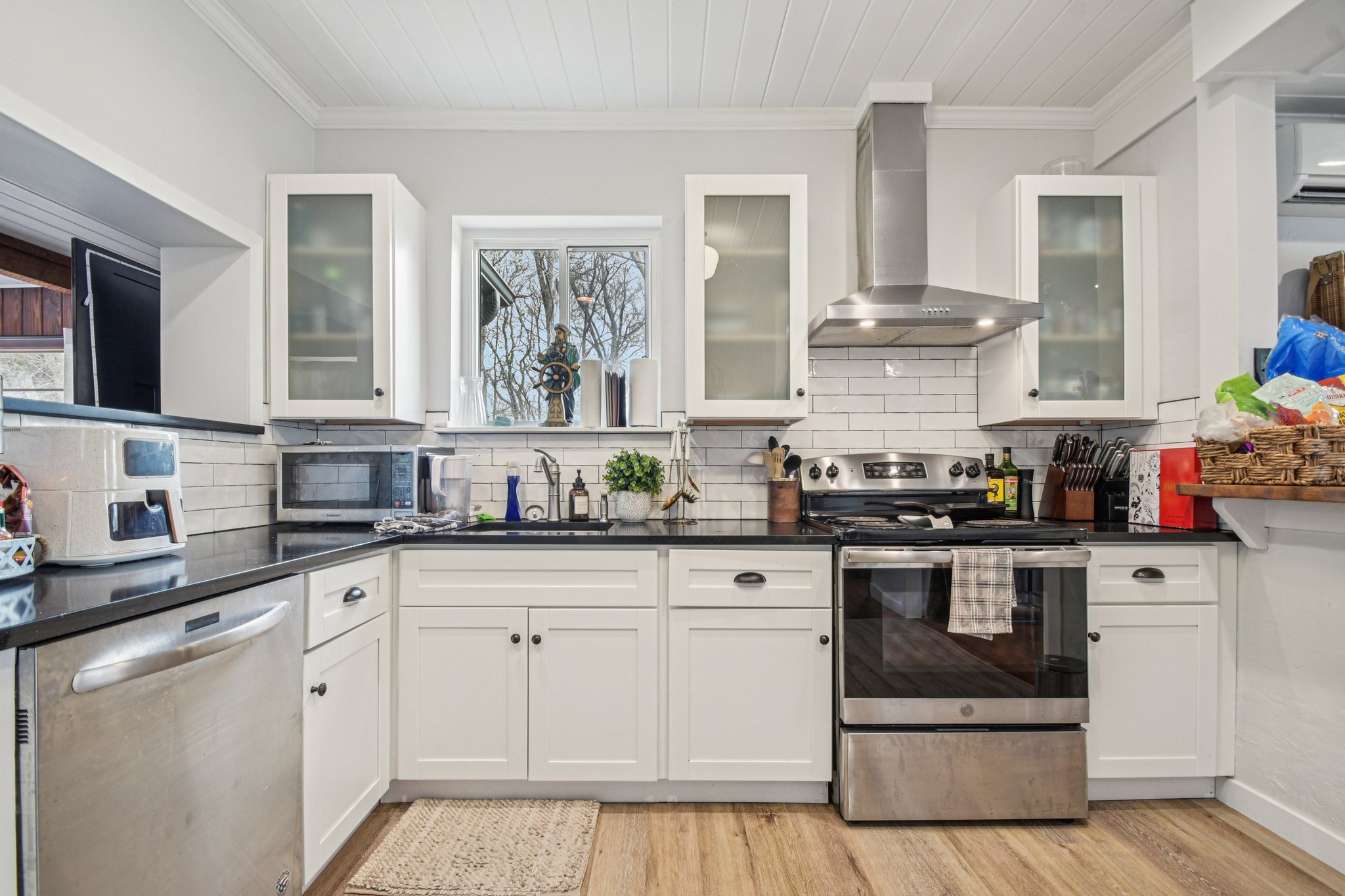 2108 River Hills Road Austin, TX 78733 - Photo 10 of 35 a kitchen with white cabinets and white appliances