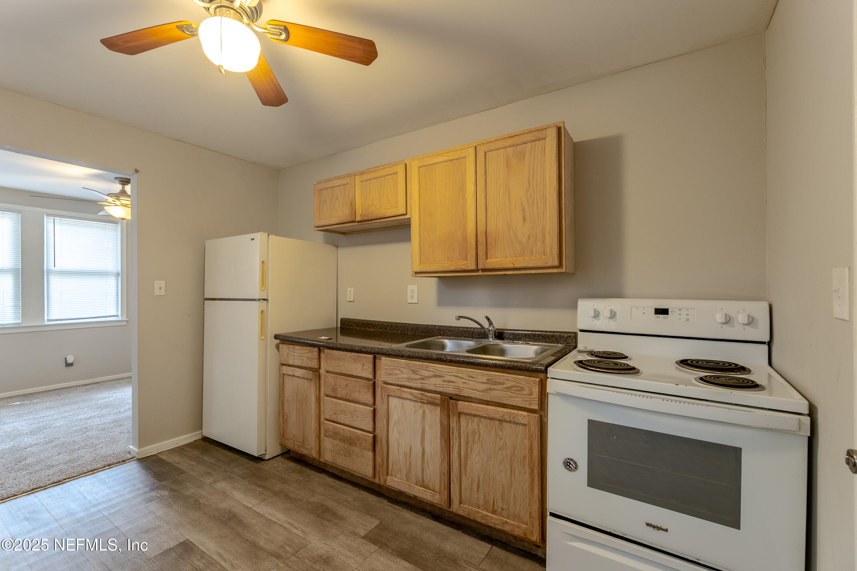 2387 2nd Avenue Jacksonville, FL 32208 - Photo 11 of 20 a kitchen with stainless steel appliances granite countertop a stove a refrigerator and a white cabinets