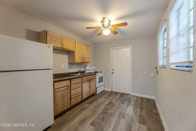 a kitchen with a refrigerator and a sink