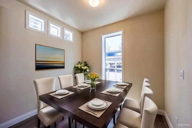 a view of a dining room with furniture and wooden floor