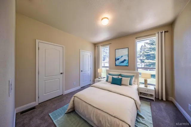 a bedroom with a large bed and a window