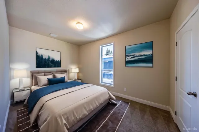 a bedroom with bed and painting on the wall