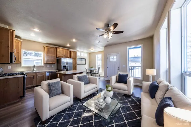 a living room with furniture a ceiling fan and a window