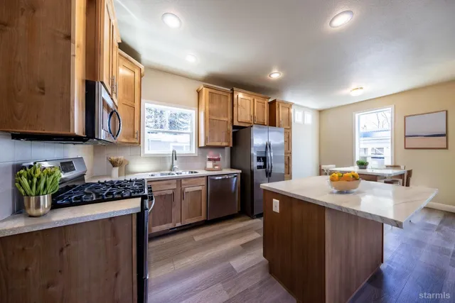 a kitchen with refrigerator cabinets and wooden floor