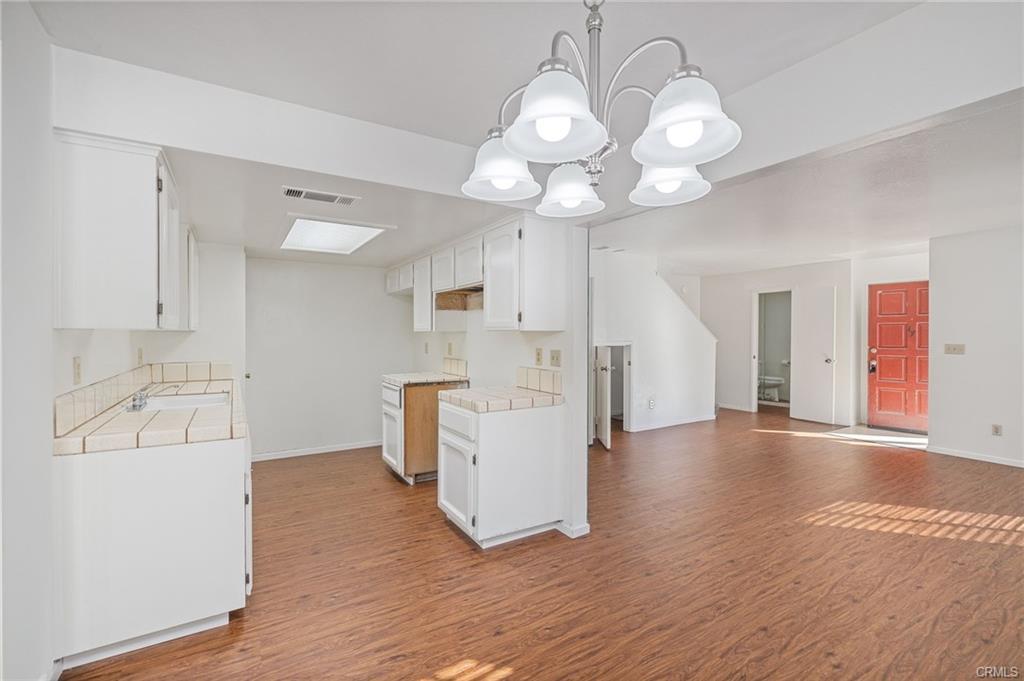 49400 River Park Road, Unit 17 Oakhurst, CA 93644 - Photo 32 of 34 a view of a kitchen with a sink dishwasher and wooden floor