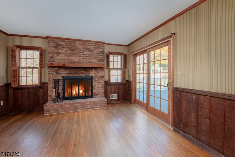 64 Old Coach Road Bernards, NJ 07920 - Photo 11 of 32 a view of an empty room with wooden floor fireplace and a window
