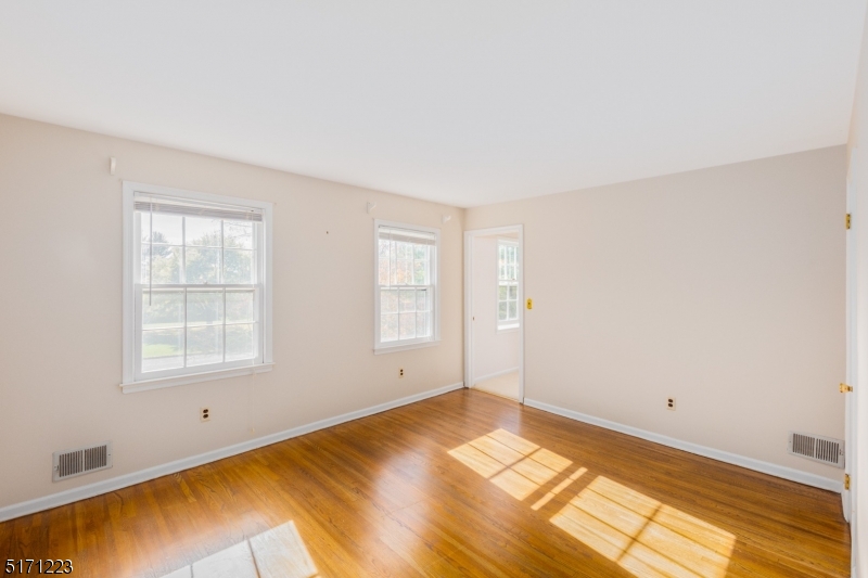 64 Old Coach Road Bernards, NJ 07920 - Photo 20 of 32 a view of empty room with wooden floor and fan