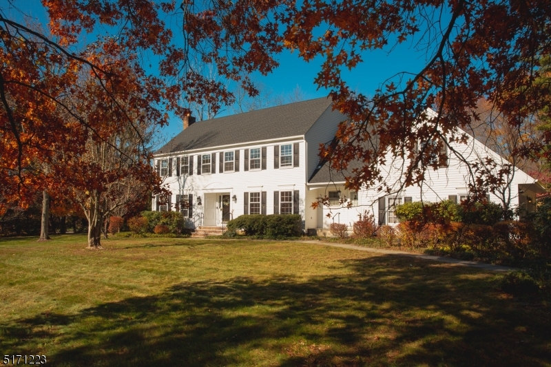 64 Old Coach Road Bernards, NJ 07920 - Photo 2 of 32 a front view of a house with a garden