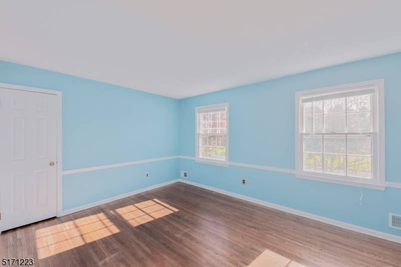 64 Old Coach Road Bernards, NJ 07920 - Photo 21 of 32 a view of empty room with wooden floor and fan