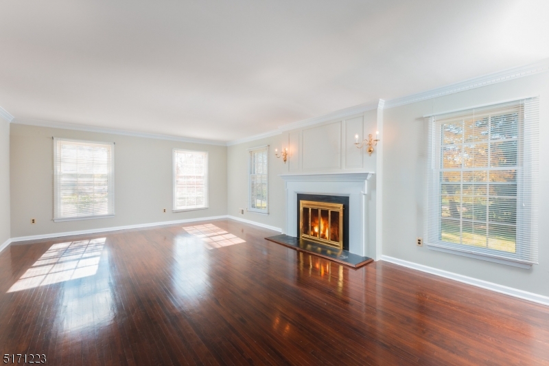 64 Old Coach Road Bernards, NJ 07920 - Photo 7 of 32 a view of empty room with wooden floor and fireplace