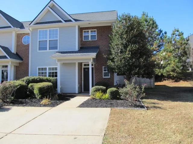 a front view of a house with a yard and a garage