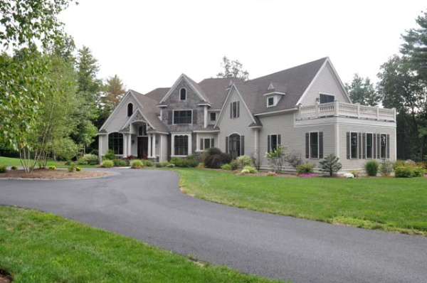 a front view of a house with a garden and porch