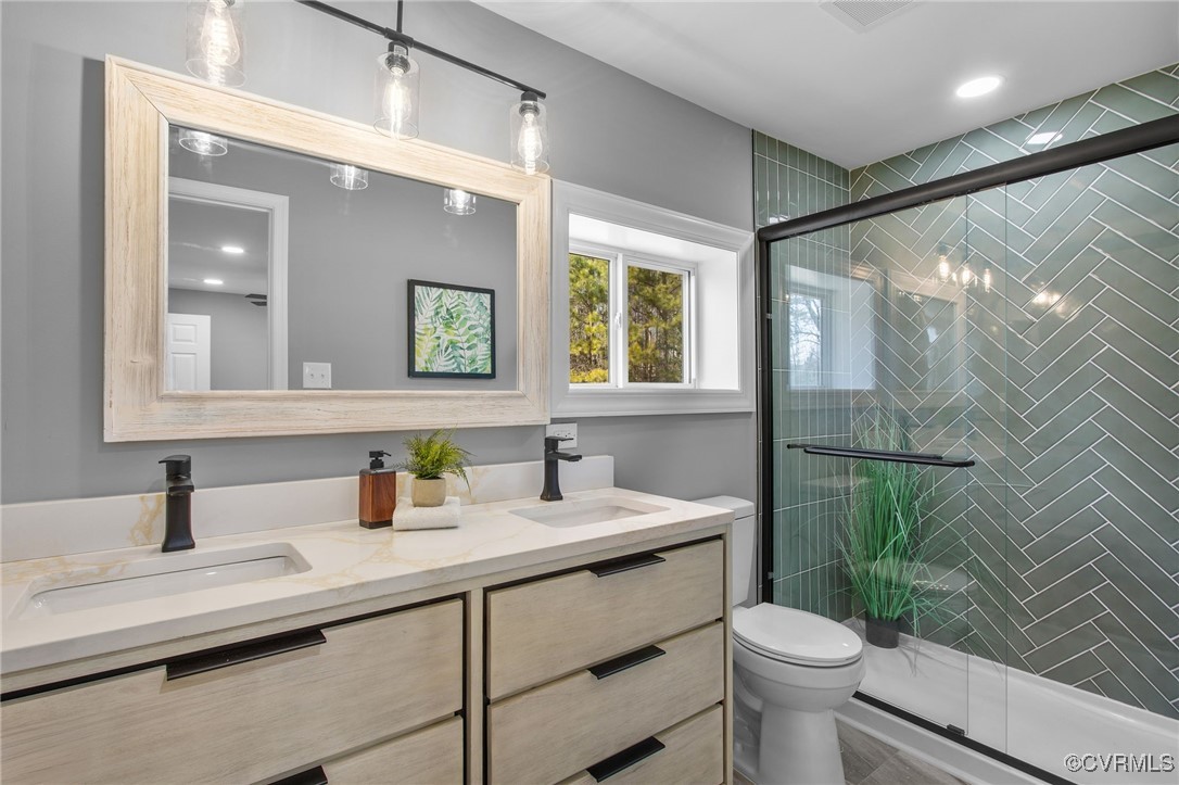 8501 Barnetts Road Charles City, VA 23030 - Photo 19 of 33 Bathroom featuring a sink, a shower stall, toilet,