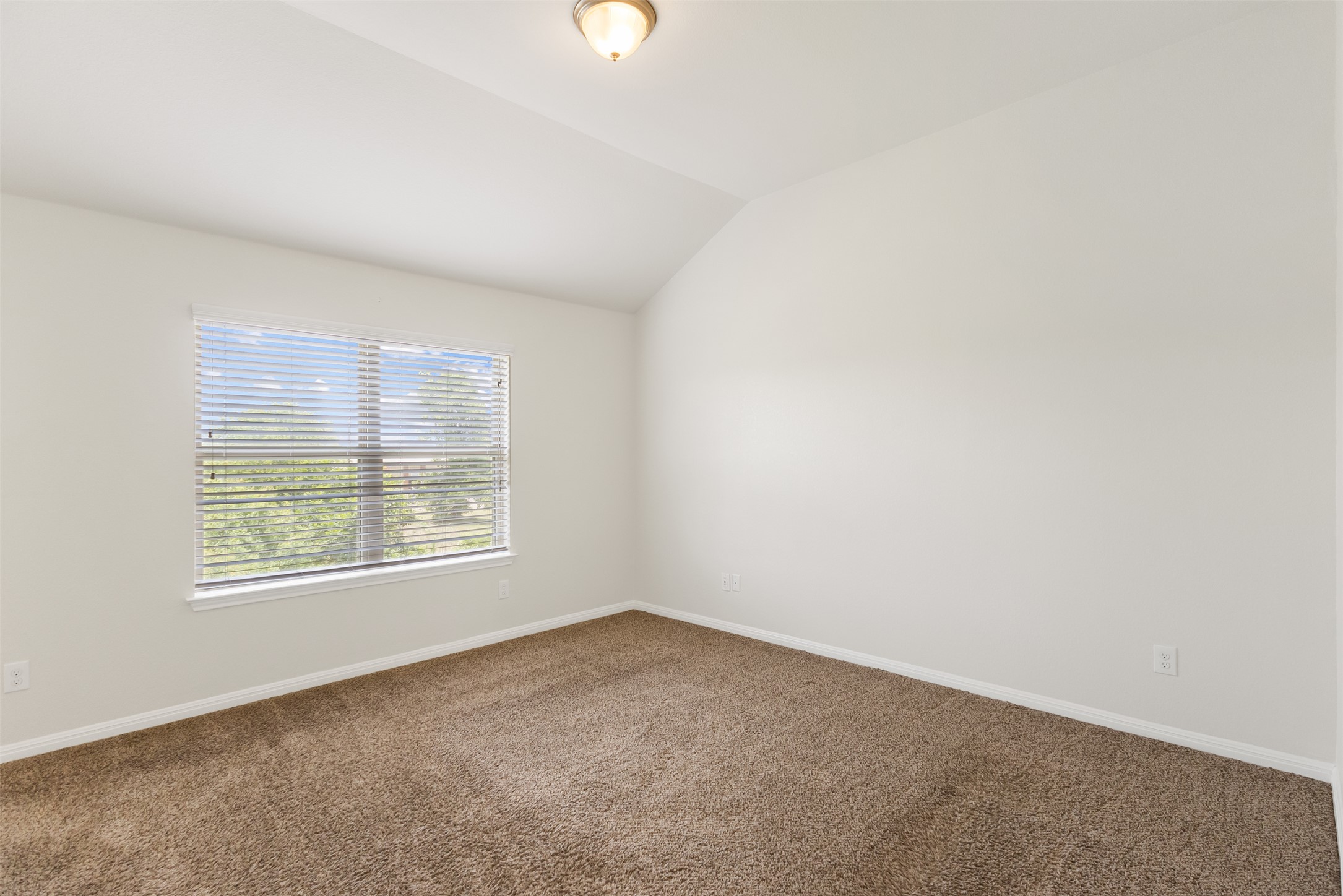 1510 Catalan Road, Unit 602 Austin, TX 78748 - Photo 17 of 36 Carpeted spare room featuring lofted ceiling and baseboards