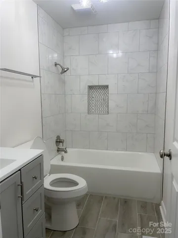 a bathroom with a toilet a sink and bathtub