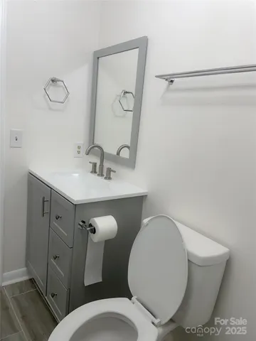 a bathroom with a toilet a sink and mirror