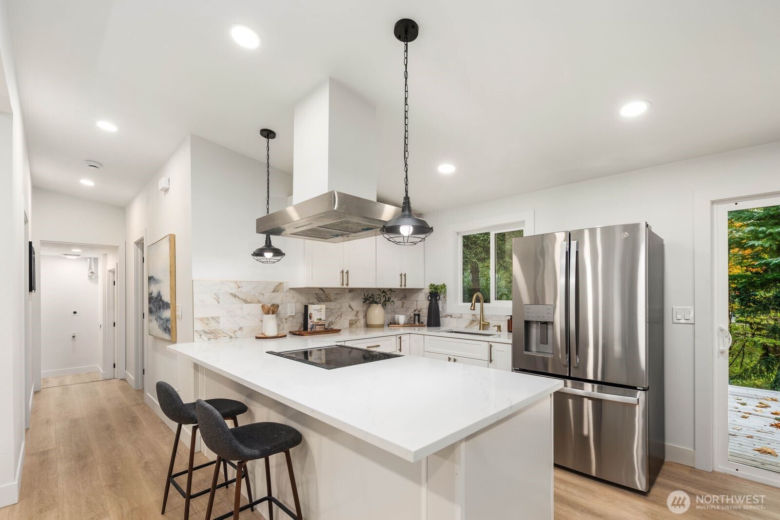 14866 154th Place Southeast Renton, WA 98058 - Photo 11 of 36 a kitchen with stainless steel appliances a refrigerator sink and stove