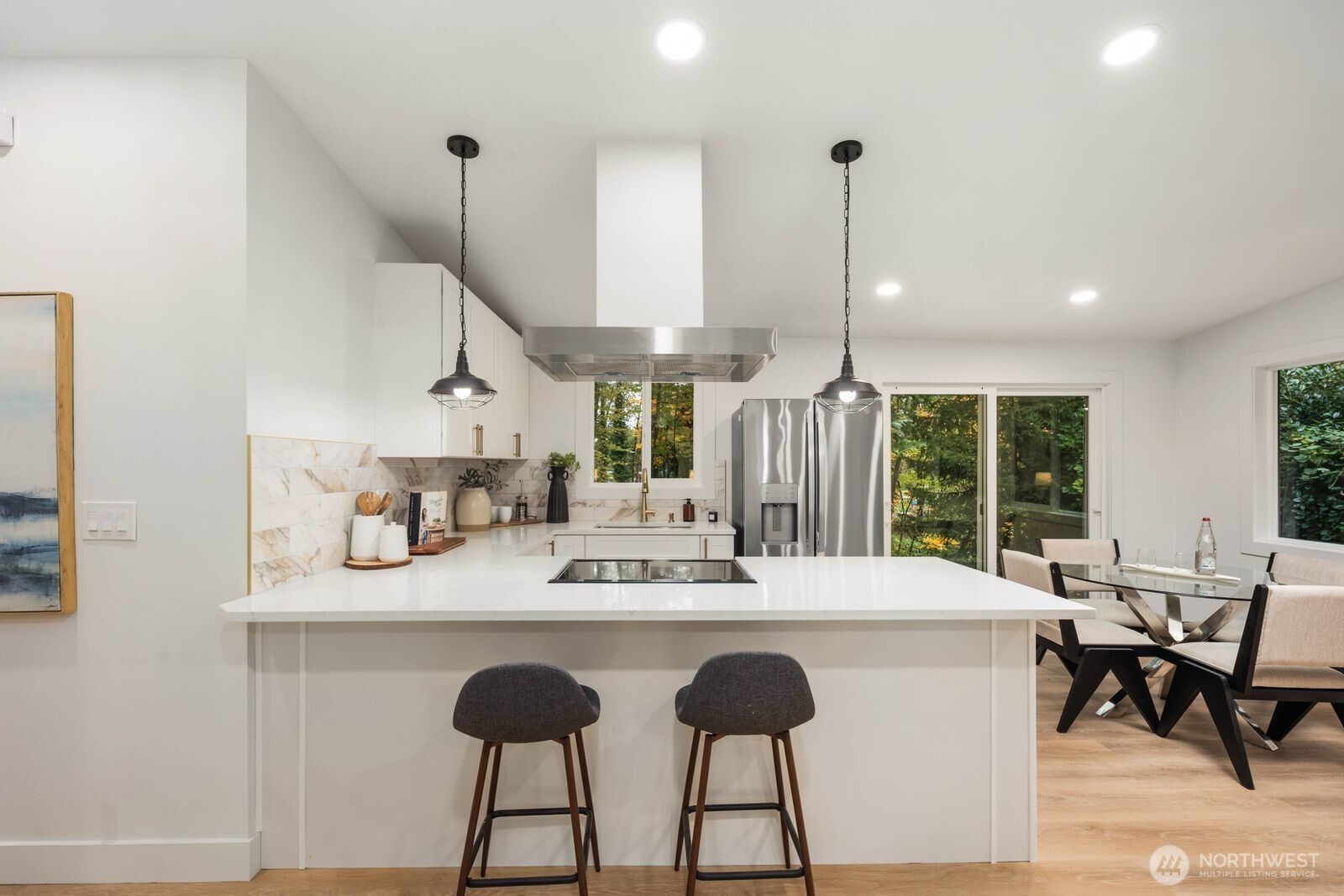 14866 154th Place Southeast Renton, WA 98058 - Photo 12 of 36 a dining hall with stainless steel appliances kitchen island a table and chairs