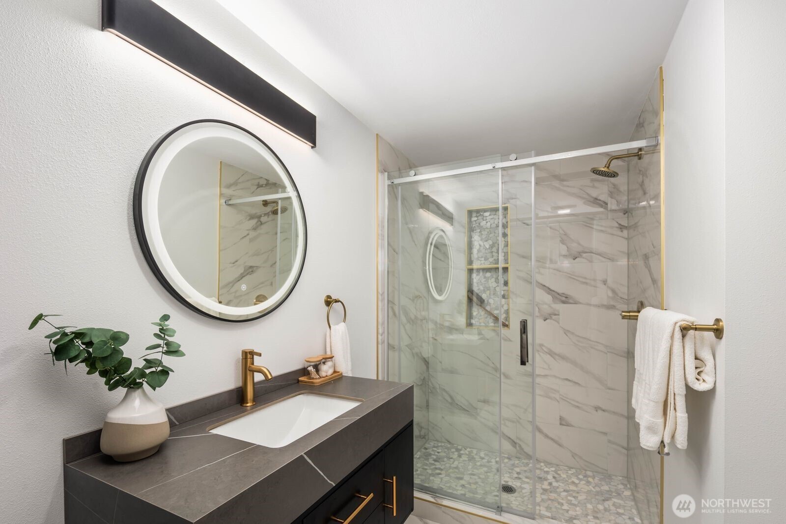 14866 154th Place Southeast Renton, WA 98058 - Photo 26 of 36 a bathroom with a sink a mirror and a shower