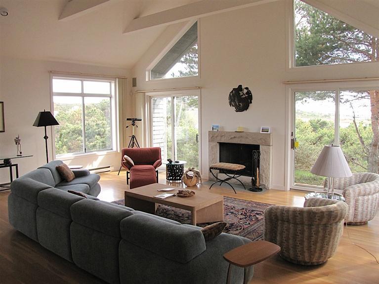 16 Cormorant Road Truro, MA 02666 - Photo 11 of 21 a living room with furniture a large window and a fireplace