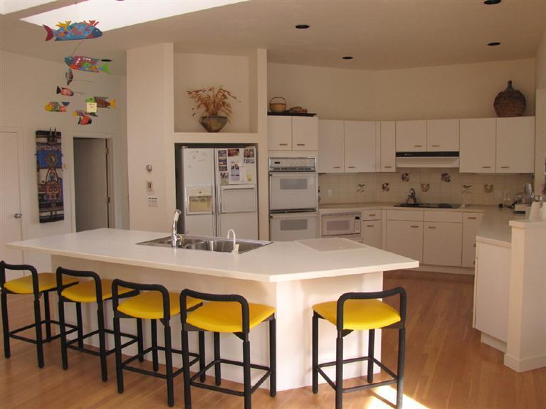 16 Cormorant Road Truro, MA 02666 - Photo 15 of 21 a kitchen with stainless steel appliances granite countertop a table and chairs in it