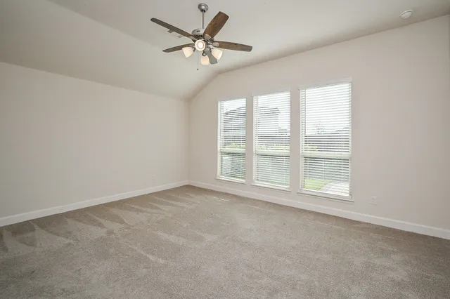 a view of empty room with wooden floor and window