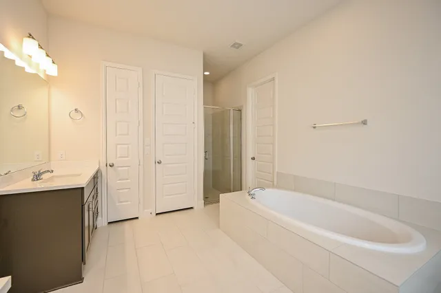 a bathroom with a sink a toilet a tub and shower