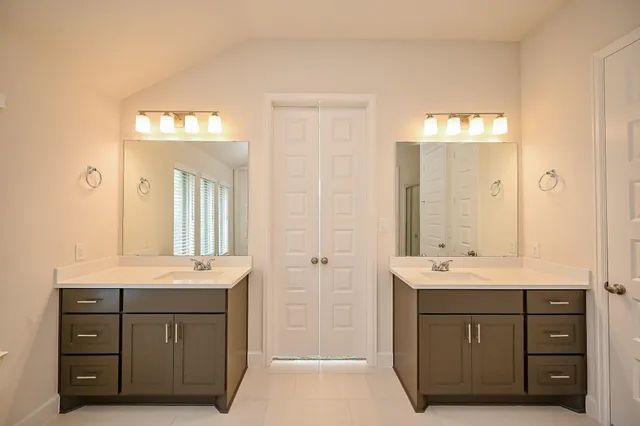 a spacious bathroom with a bathtub sink and mirror