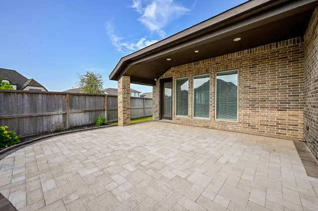 a view of house with backyard and outdoor seating
