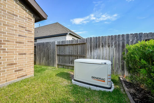 a view of backyard with wooden fence