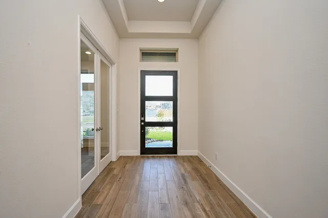 wooden floor in an empty room with a window