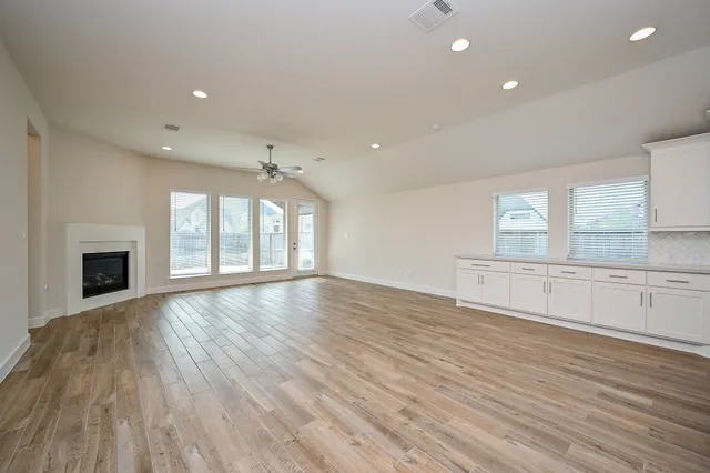 a kitchen with stainless steel appliances granite countertop a sink stove and wooden floor