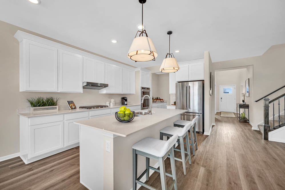 312 Astor Court Elgin, IL 60124 - Photo 7 of 28 a kitchen that has a lot of cabinets a counter space and wooden floor
