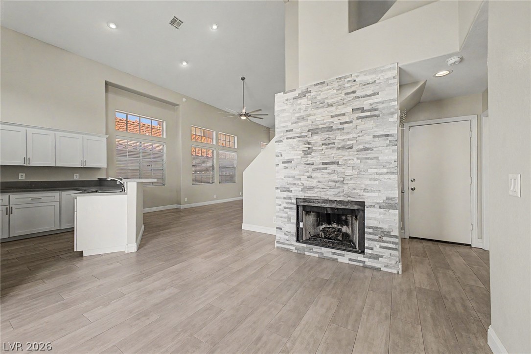 2316 Ramsgate Drive Henderson, NV 89074 - Photo 8 of 28 A striking stacked stone fireplace and lofty ceilings define this inviting living space.
