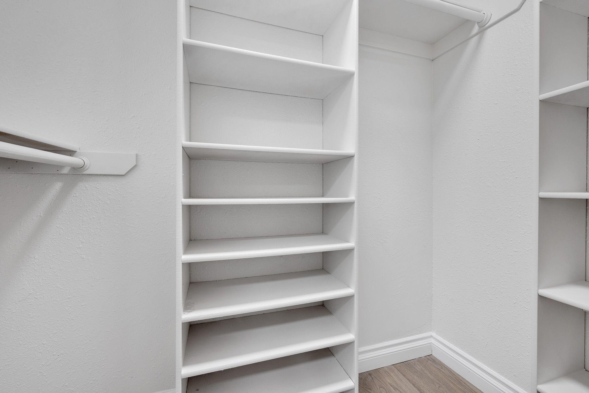 1301 East Avenue I Lancaster, CA 93535 - Photo 14 of 25 a view of walk in closet with empty racks