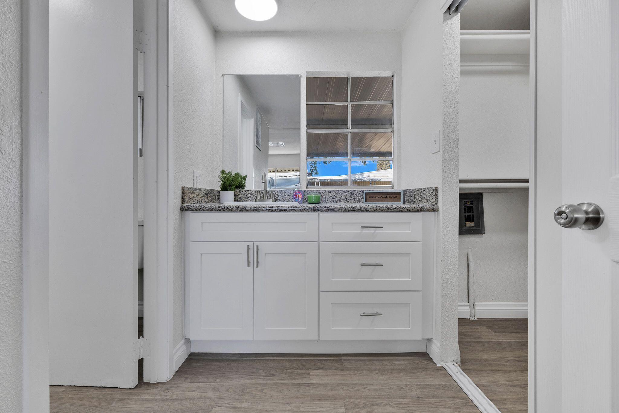 1301 East Avenue I Lancaster, CA 93535 - Photo 17 of 25 a kitchen with granite countertop cabinets and a stove