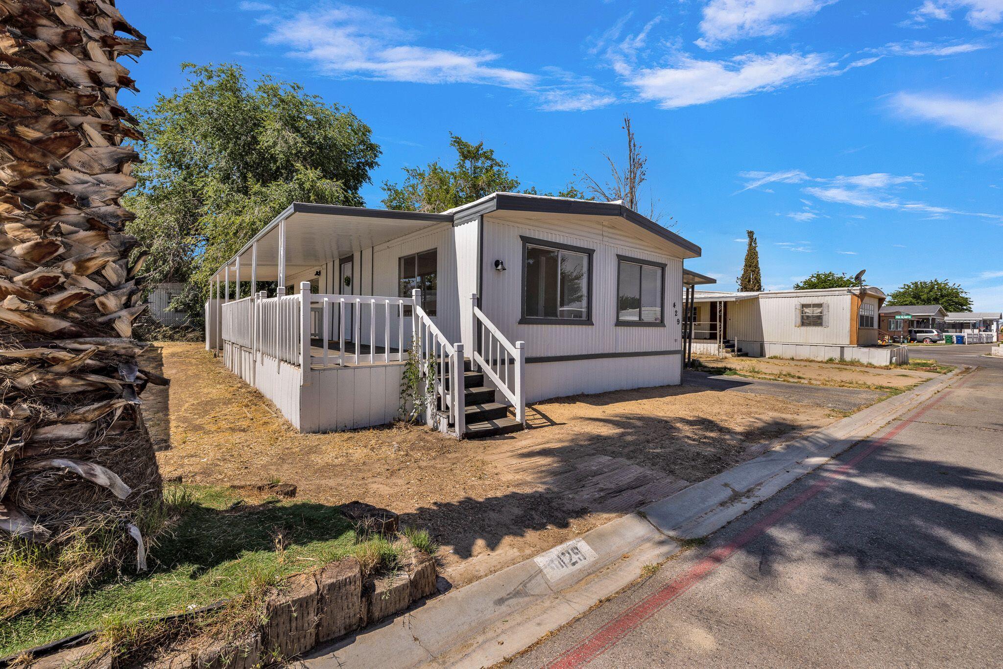 1301 East Avenue I Lancaster, CA 93535 - Photo 2 of 25 a front view of a house with a yard