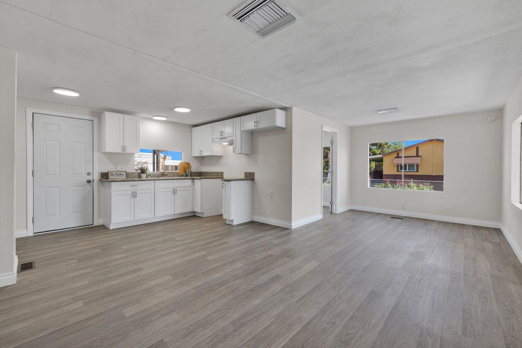 1301 East Avenue I Lancaster, CA 93535 - Photo 3 of 25 a view of kitchen with wooden floor and electronic appliances