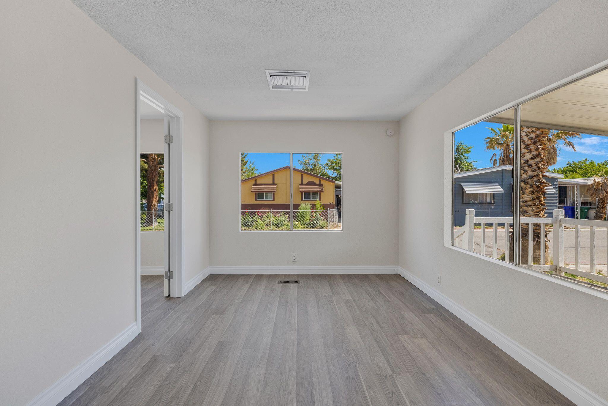 1301 East Avenue I Lancaster, CA 93535 - Photo 4 of 25 a view of an empty room with a window and wooden floor