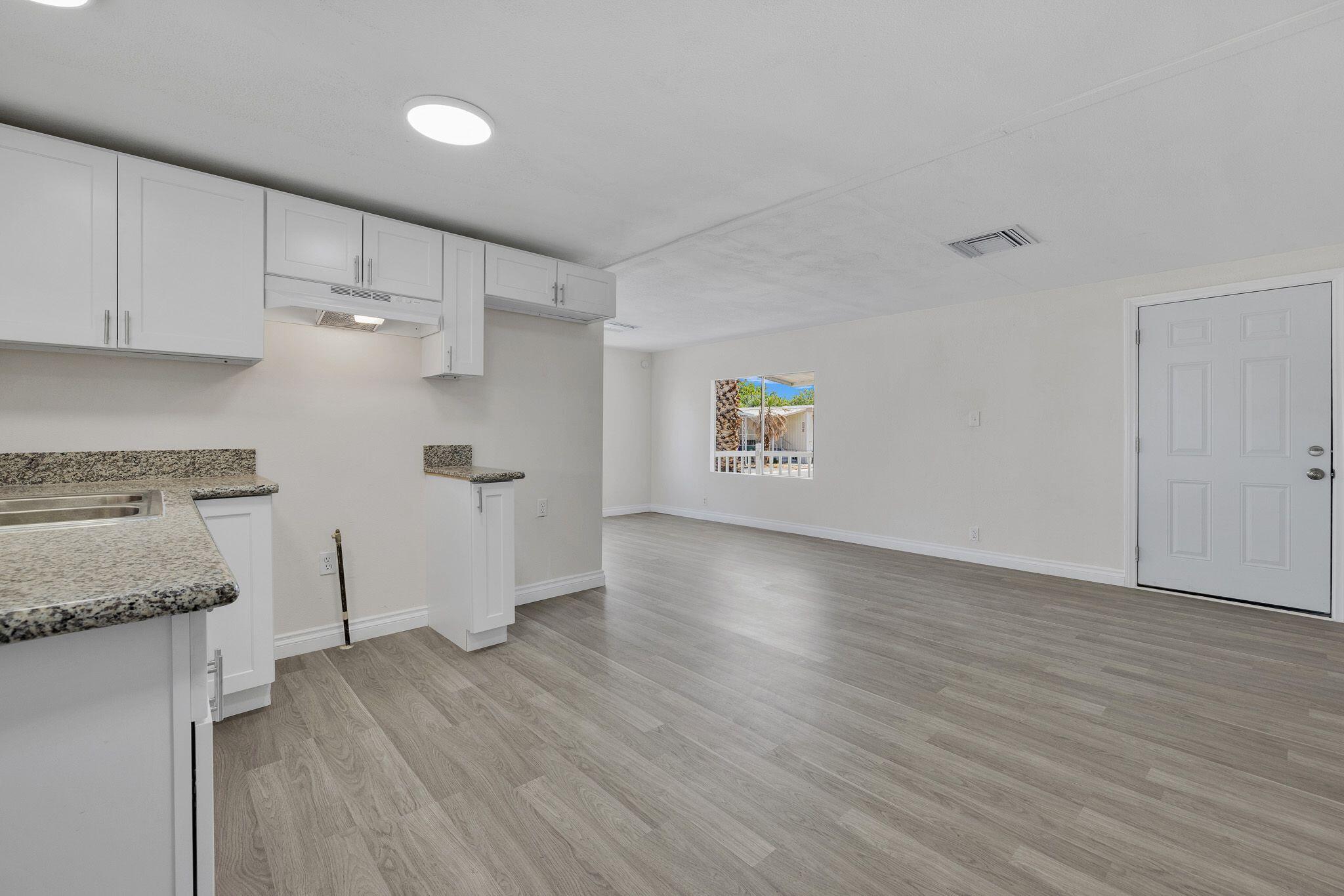 1301 East Avenue I Lancaster, CA 93535 - Photo 7 of 25 a view of a kitchen with wooden floor