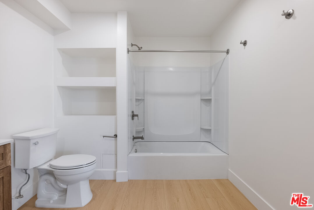 8561 Belmont Street, Unit 4 Cypress, CA 90630 - Photo 12 of 23 a bathroom with a toilet and a shower