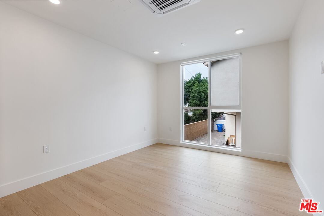 8561 Belmont Street, Unit 4 Cypress, CA 90630 - Photo 14 of 23 a view of a room with wooden floor and a window