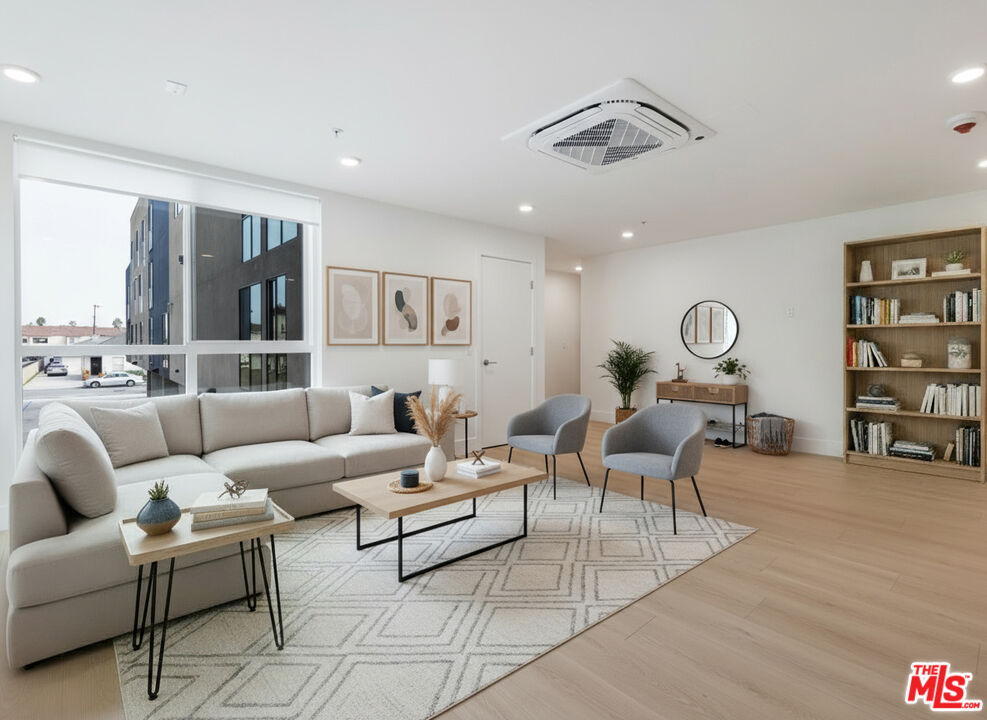 8561 Belmont Street, Unit 4 Cypress, CA 90630 - Photo 19 of 23 a living room with furniture and wooden floor
