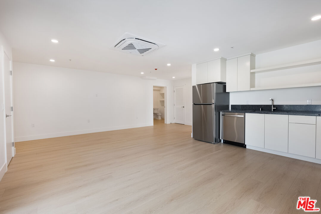 8561 Belmont Street, Unit 4 Cypress, CA 90630 - Photo 9 of 23 a kitchen with stainless steel appliances a refrigerator and a sink