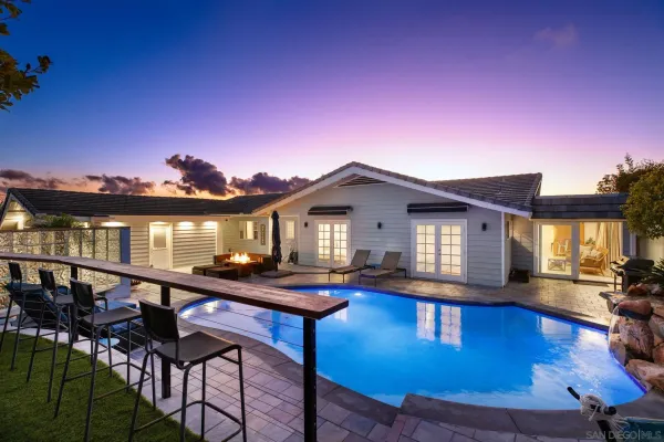 a swimming pool view with a seating space