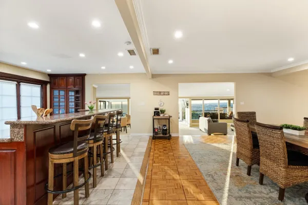 a living room with lots of furniture and kitchen view