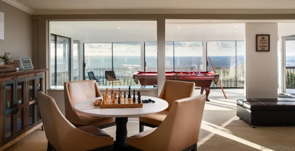 a dining room with furniture a chandelier and wooden floor