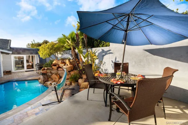 a patio with a patio table and chairs