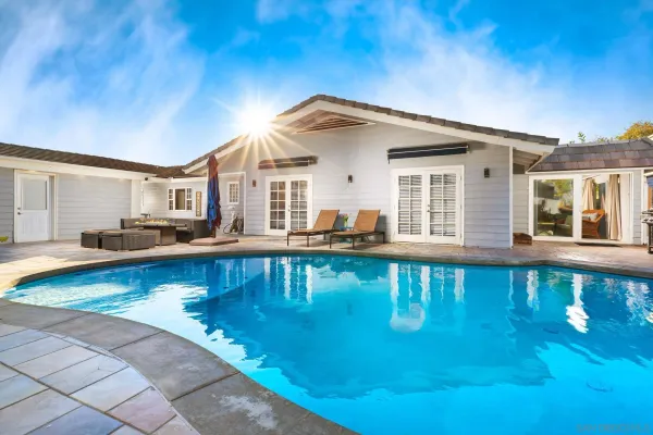 a view of a house with swimming pool and sitting area