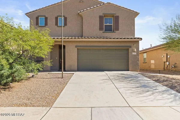 a front view of a house with a yard